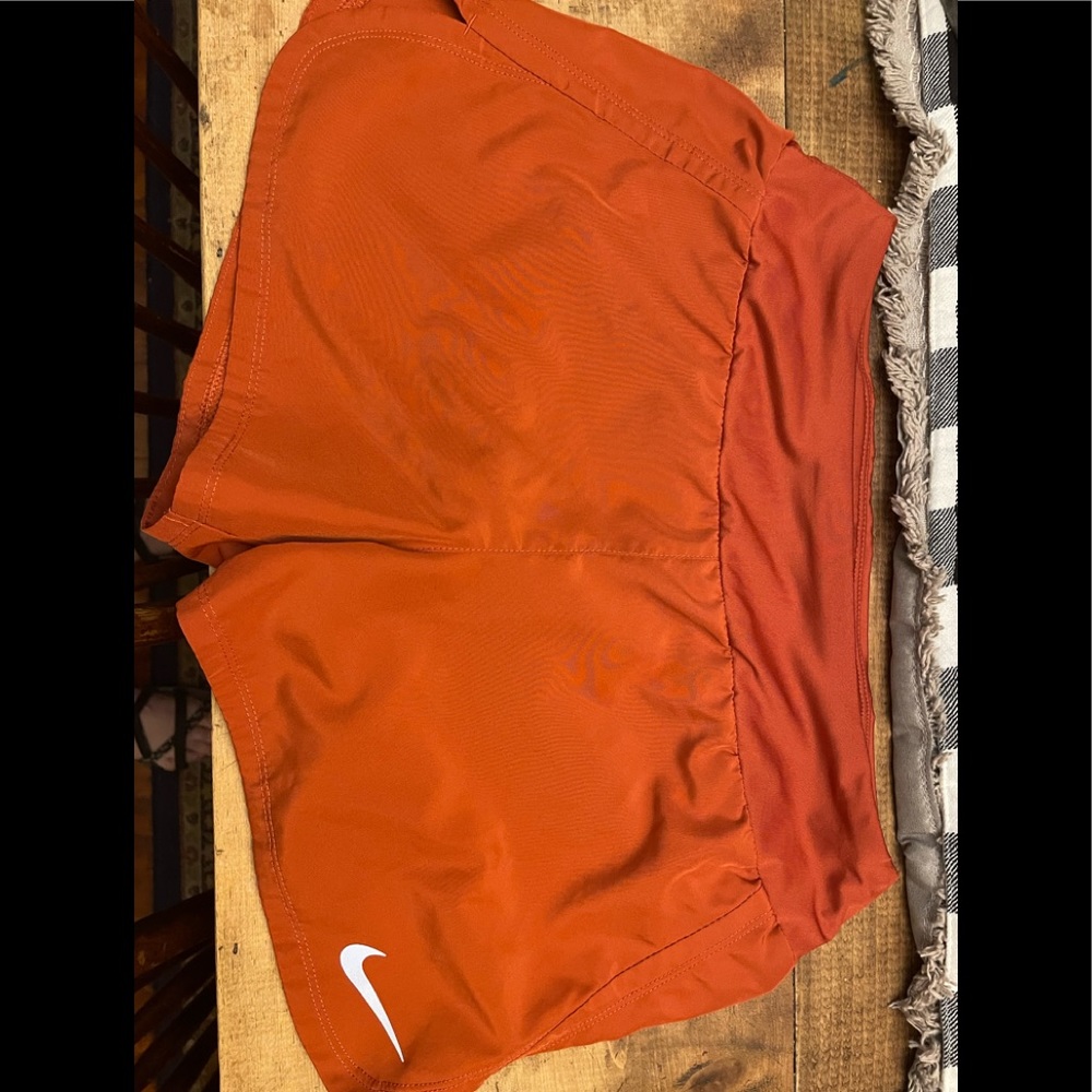 Nike Dry Fit Womens size S shorts ,Copper orange color, back pocket, lined.